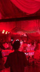 Wedding reception celebrates in red-lit venue in Nigeria