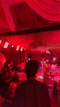 Wedding reception celebrates in red-lit venue in Nigeria