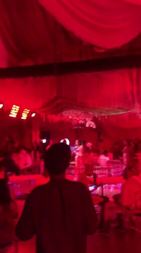 Wedding reception celebrates in red-lit venue in Nigeria