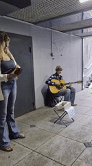 Wet streets and a busker in a Vladivostok underpass