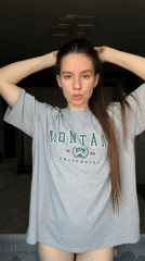 Woman takes multiple selfies in Montana University shirt