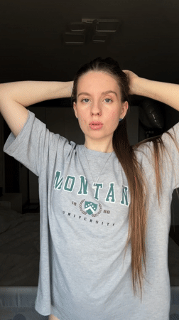 Woman takes multiple selfies in Montana University shirt