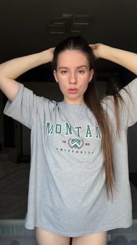 Woman takes multiple selfies in Montana University shirt