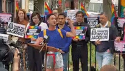 Outdoor demonstration with speakers and signs in NYC