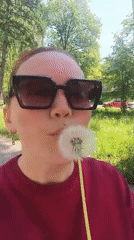 Woman documents sunny morning outing at park with fountains