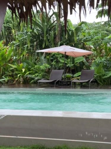 Morning rain and yoga captured at tropical retreat
