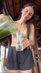 Woman prepares green smoothies in Mũi Né kitchen