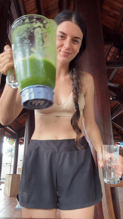 Woman prepares green smoothies in Mũi Né kitchen