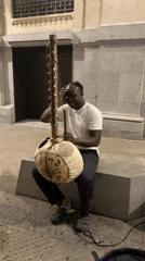 Kora player busking outside an ornate Madrid building