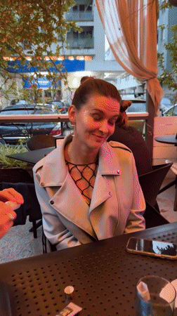 Women apply makeup, socialize at outdoor bar in Montenegro
