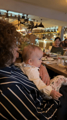 Baby and caregiver share moment at Khimki restaurant
