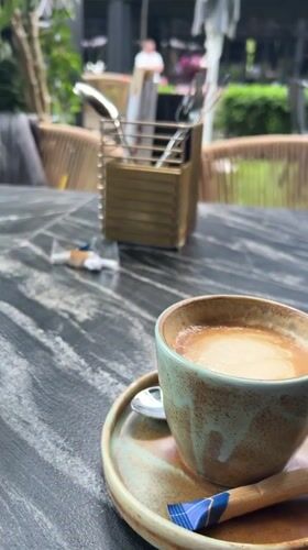 Coffee break documented at Warsaw outdoor cafe