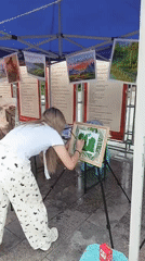 Woman paints outdoors under tent in Chongqing High-tech Zone