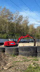 Red excavator and dumper truck at a Most, Czechia work site