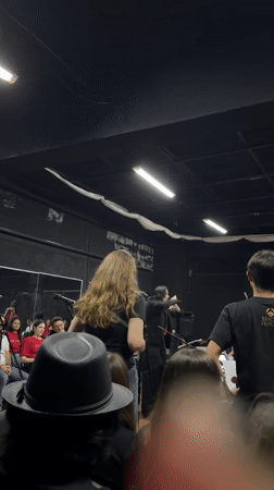 Orchestral concert in San Bernardino Tlaxcalancingo, conductor leading red-shirted ensemble