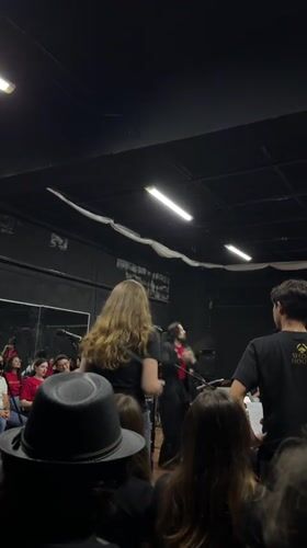 Orchestral concert in San Bernardino Tlaxcalancingo, conductor leading red-shirted ensemble