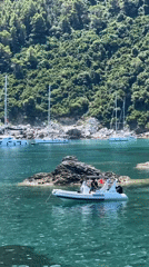 Boats exploring a rocky cove off the Loutraki coast