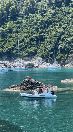 Boats exploring a rocky cove off the Loutraki coast