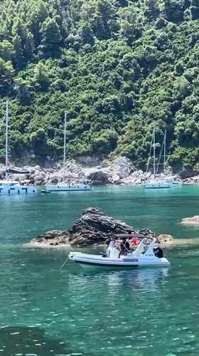 Boats exploring a rocky cove off the Loutraki coast