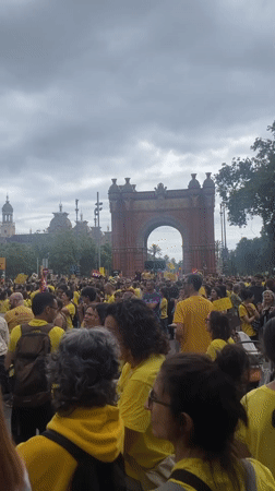 Yellow-shirted demonstrators gather at Barcelona's Arc de Triomf