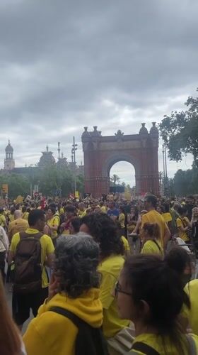 Yellow-shirted demonstrators gather at Barcelona's Arc de Triomf