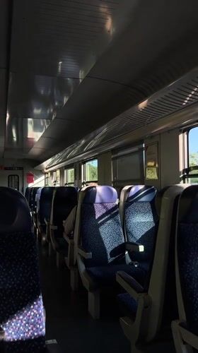 Empty train carriage rolling through Austria, midday