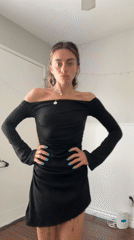 Woman models outfits during bedroom photo session in Seal Beach