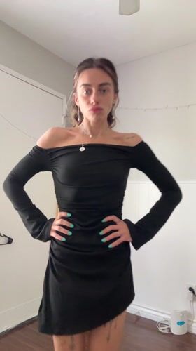 Woman models outfits during bedroom photo session in Seal Beach