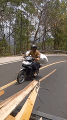 Motorcycle hauling cargo along a quiet Wonogondo road