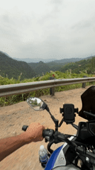 Motorcyclist rides scenic mountain road near Đà Nẵng