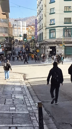 White smoke rises from crowded La Paz intersection