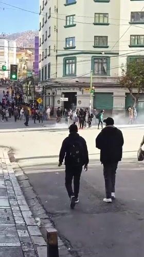White smoke rises from crowded La Paz intersection