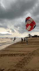 Parasailing and jet skis on a cloudy Pattaya morning