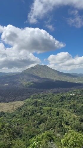 Tourist visits scenic mountain overlook in Kintamani, Indonesia