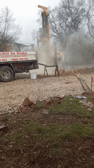 Drilling rig operates in Gurmazovo Bulgaria creating dust clouds