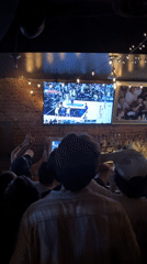 NYC bar patrons cheer during late-night basketball broadcast