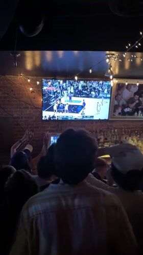 NYC bar patrons cheer during late-night basketball broadcast