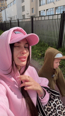 Woman in pink takes morning selfies in Saint Petersburg