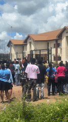 Tense crowd gathers outside building in Ihiagwa, Nigeria