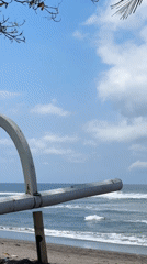 Black sand beach and coastal temple on Bali's shoreline