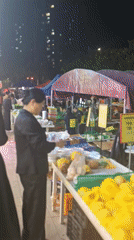 Shoppers browse produce stalls at Chongqing market
