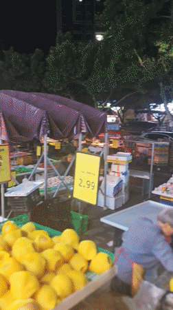 Shoppers browse produce stalls at Chongqing market