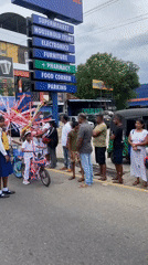Children ride decorated bicycles through Galle streets