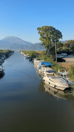 Morning along Fethiye's harbor — beach, canal, and boats