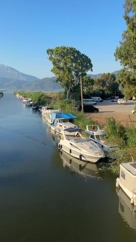 Morning along Fethiye's harbor — beach, canal, and boats