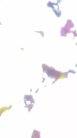 A close-up, blurry shot shows a pile of dried fruits and nuts. Visible items include dried apricots, raisins, prunes, and walnuts, all mixed together on a blue surface. The lighting is bright, casting shadows and highlighting the textures of the food.
