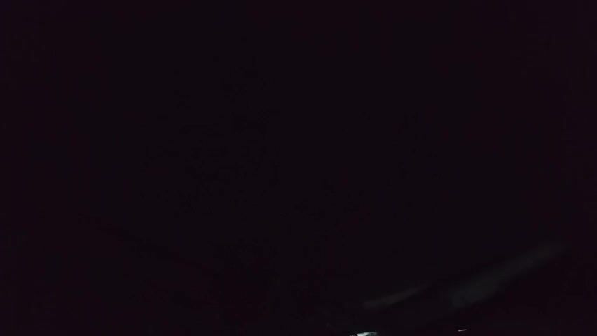 This media file is a short, dark video from Buketteukuh, Indonesia. The scene is almost entirely black, suggesting it was filmed at night or in a very dimly lit environment. In the bottom right corner, a portion of what appears to be an aircraft wing or a large, elongated object is visible, illuminated by a faint, possibly artificial light source. The object is angled diagonally upwards from the right side of the frame. There is no discernible activity or event taking place, and no people are visible. The overall impression is one of darkness and mystery, with the unidentified object being the only discernible element in the frame. No text is visible.