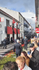 Firefighters and marching band parade through Ponta Delgada streets