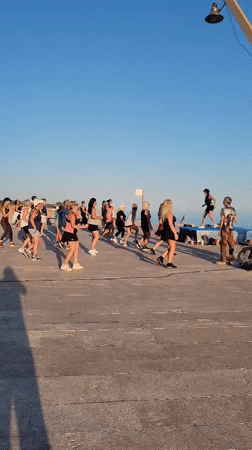 Outdoor fitness class on Quarteira's beachfront promenade