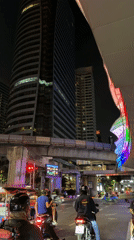 Bangkok traffic stops at red light near modern building